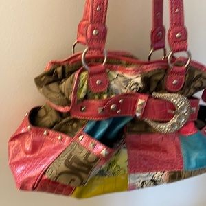 Purse with pink straps and large buckle